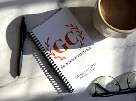 Spiral workbook on table with pen and glasses