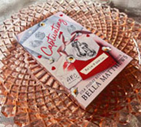 "Captivating" book cover on pink platter